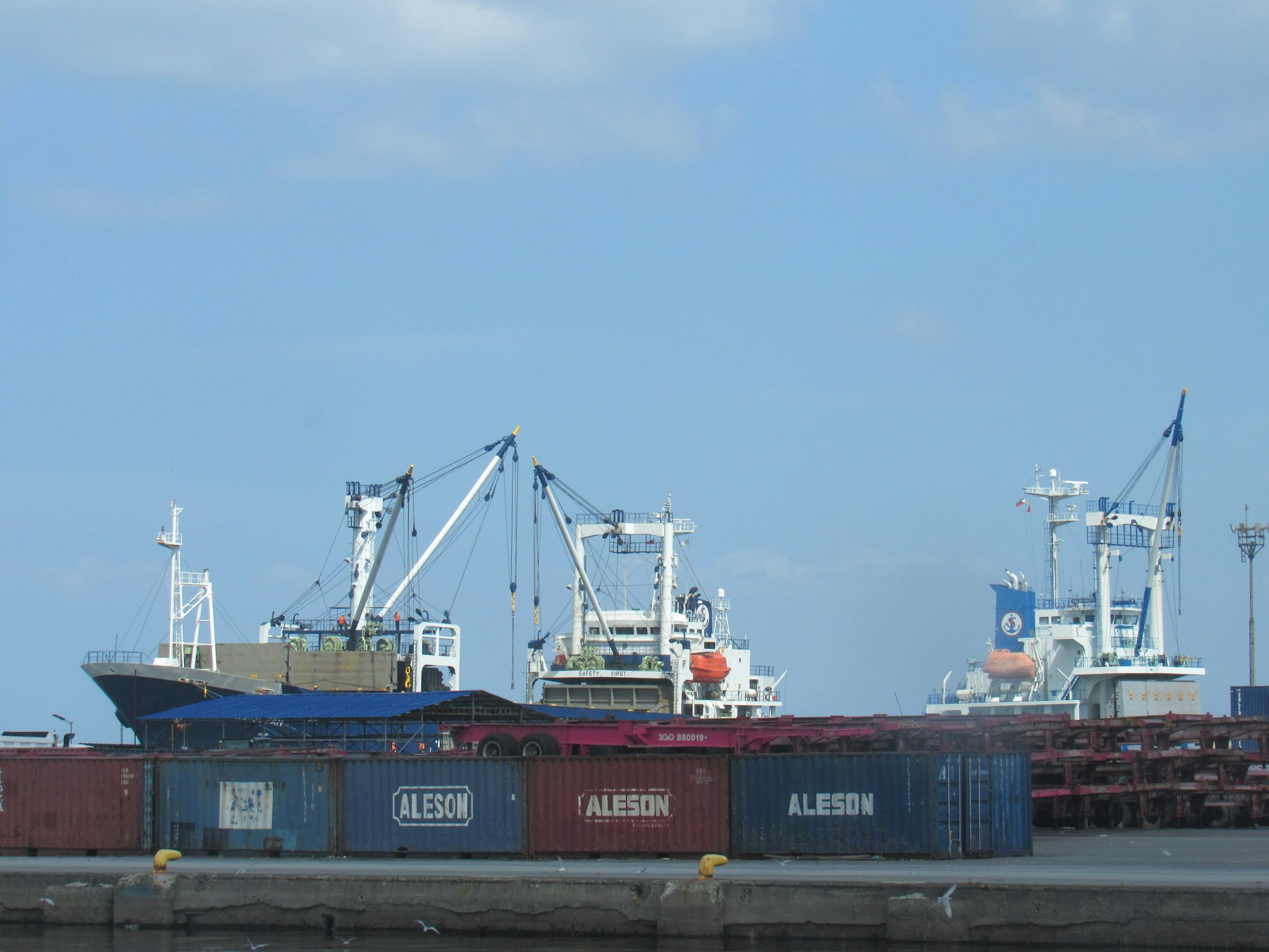 Cargo ships and containers being handled at a working port