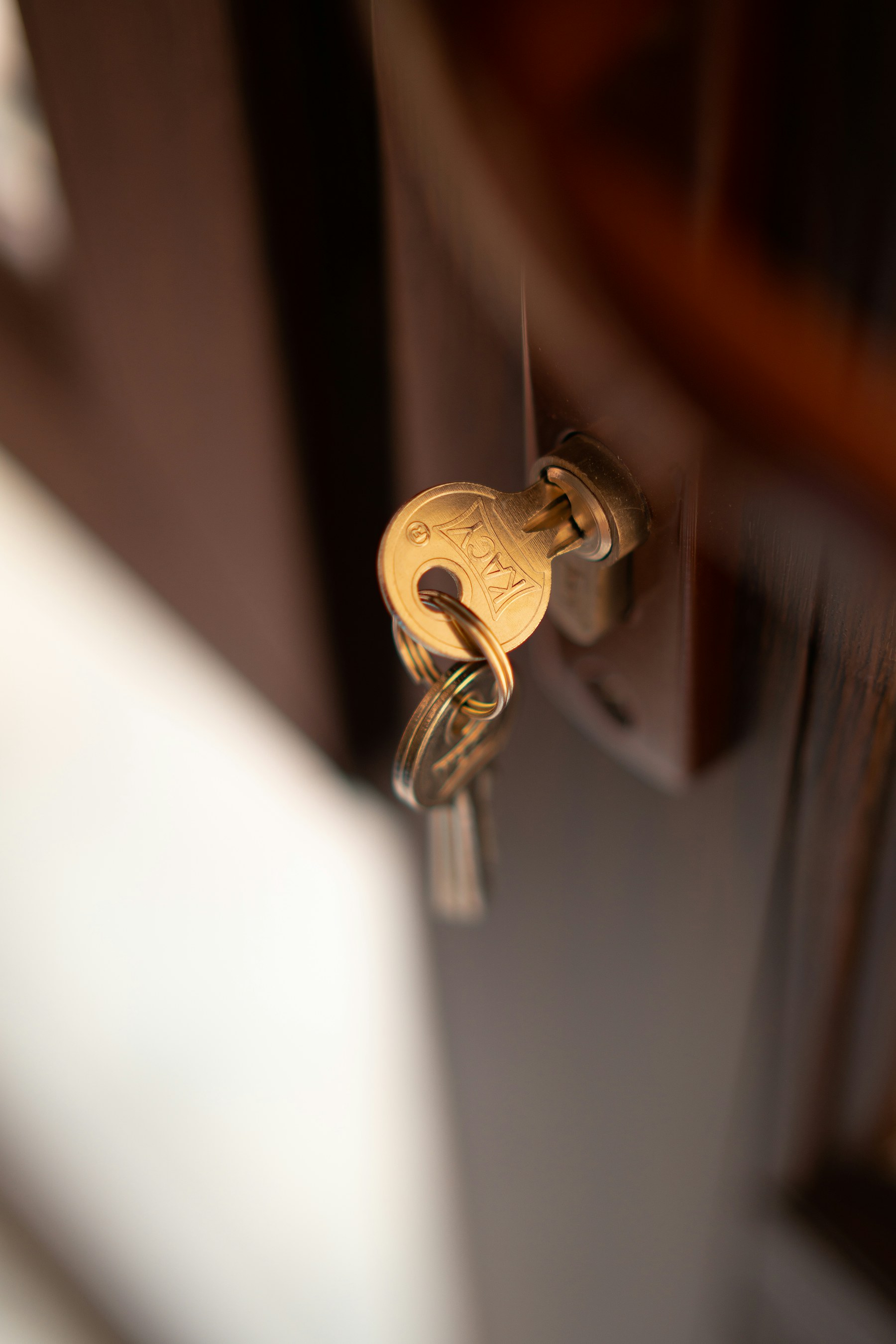 A key left in the lock of a wooden door